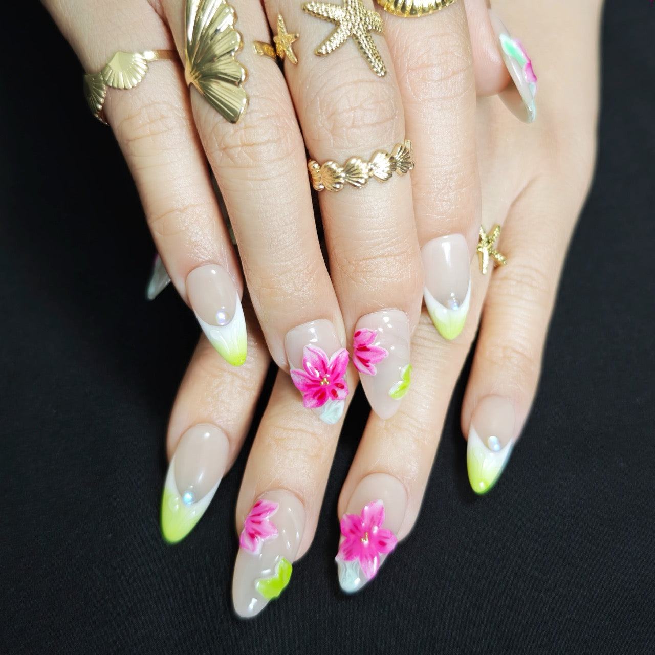 Hand wearing Island Bloom tropical floral almond press-on nails with elegant vacation manicure style