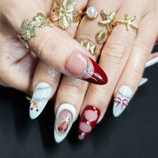 White and red almond press-on nails with hand-painted cherry and silver pearl accents, luxurious festive winter design.