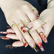 Close up of realistic 3D cherry charms on luxury handmade press on nails