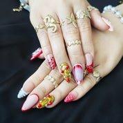 Red and gold transparent press-on nails with large 3D handcrafted petals, featuring an intricate luxury design.