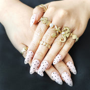 White polka dot almond-shaped press-on nails in minimal MIUMIU-inspired style, trendy for American high school teen girls