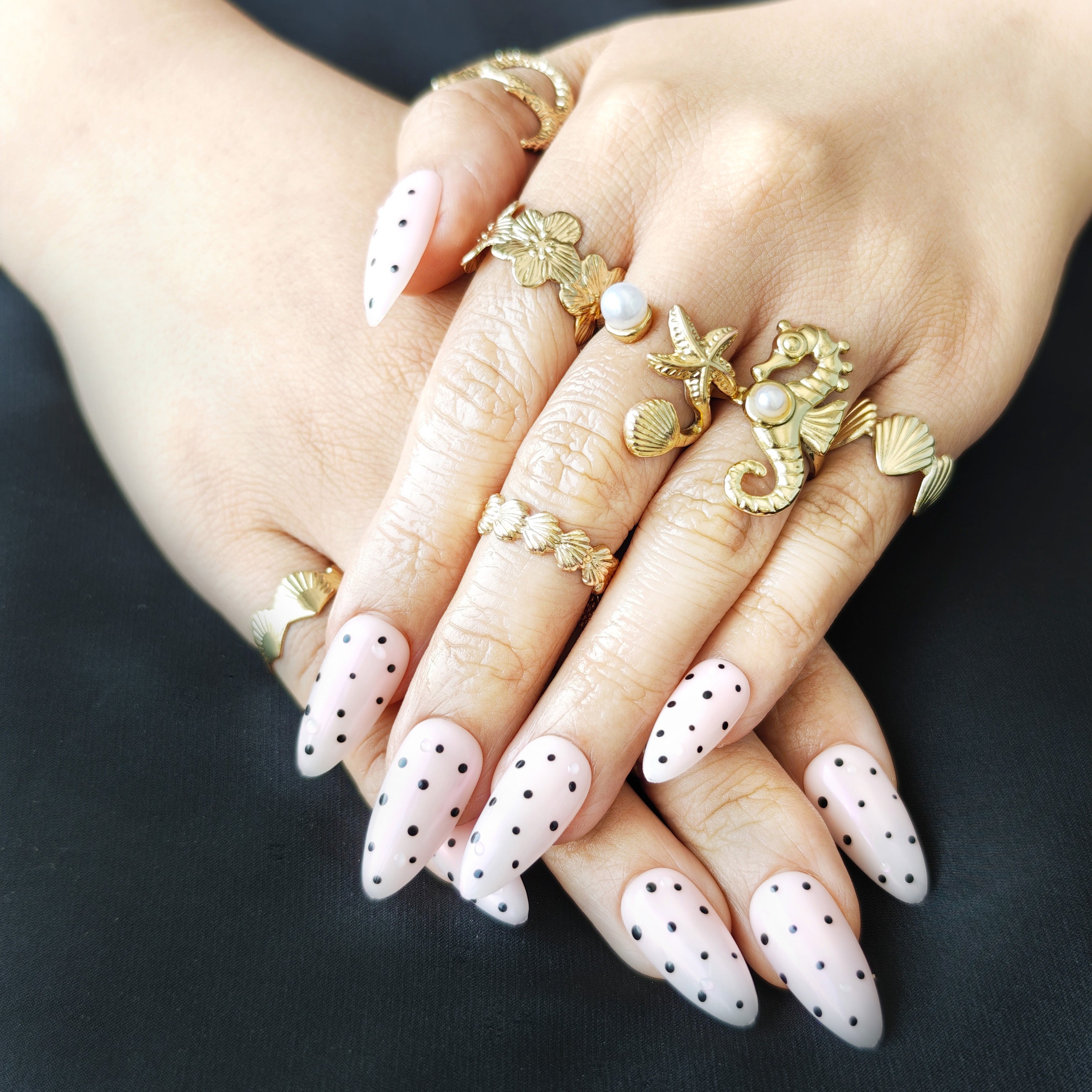 White polka dot almond-shaped press-on nails in minimal MIUMIU-inspired style, trendy for American high school teen girls