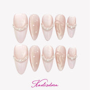 Pearl Bow almond press-on nails featuring soft pink gradient, 3D bow details, pearl embellishments, and luxury handmade nail art