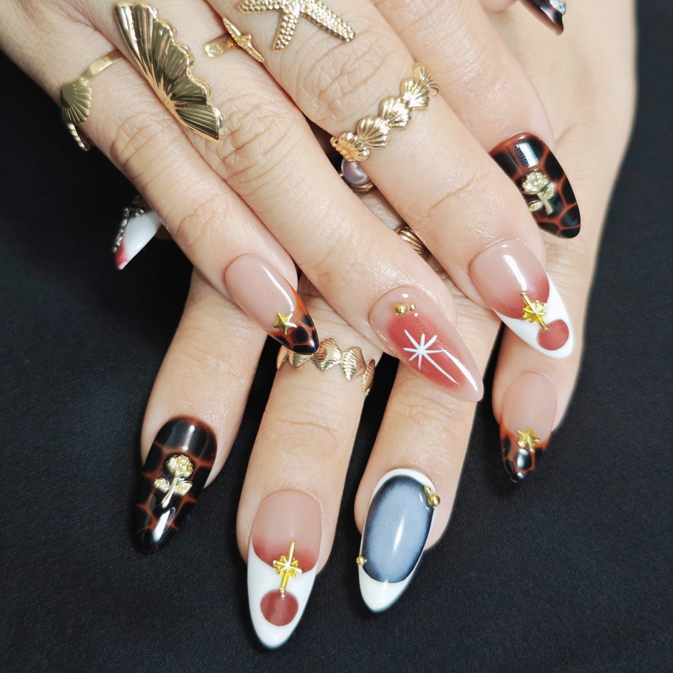 Gold and brown modern minimalist press-on nails with rose-inspired accents, handcrafted for a luxury elegant style.