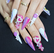 Woman wearing Y2K Candy stiletto press-on nails with 3D charms, colorful Y2K designs, and bold trendy party manicure style