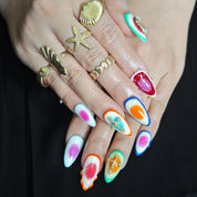Multicolor almond-shaped press-on nails adorned with cross and sparkling crystal accents for a bold, luxurious look.
