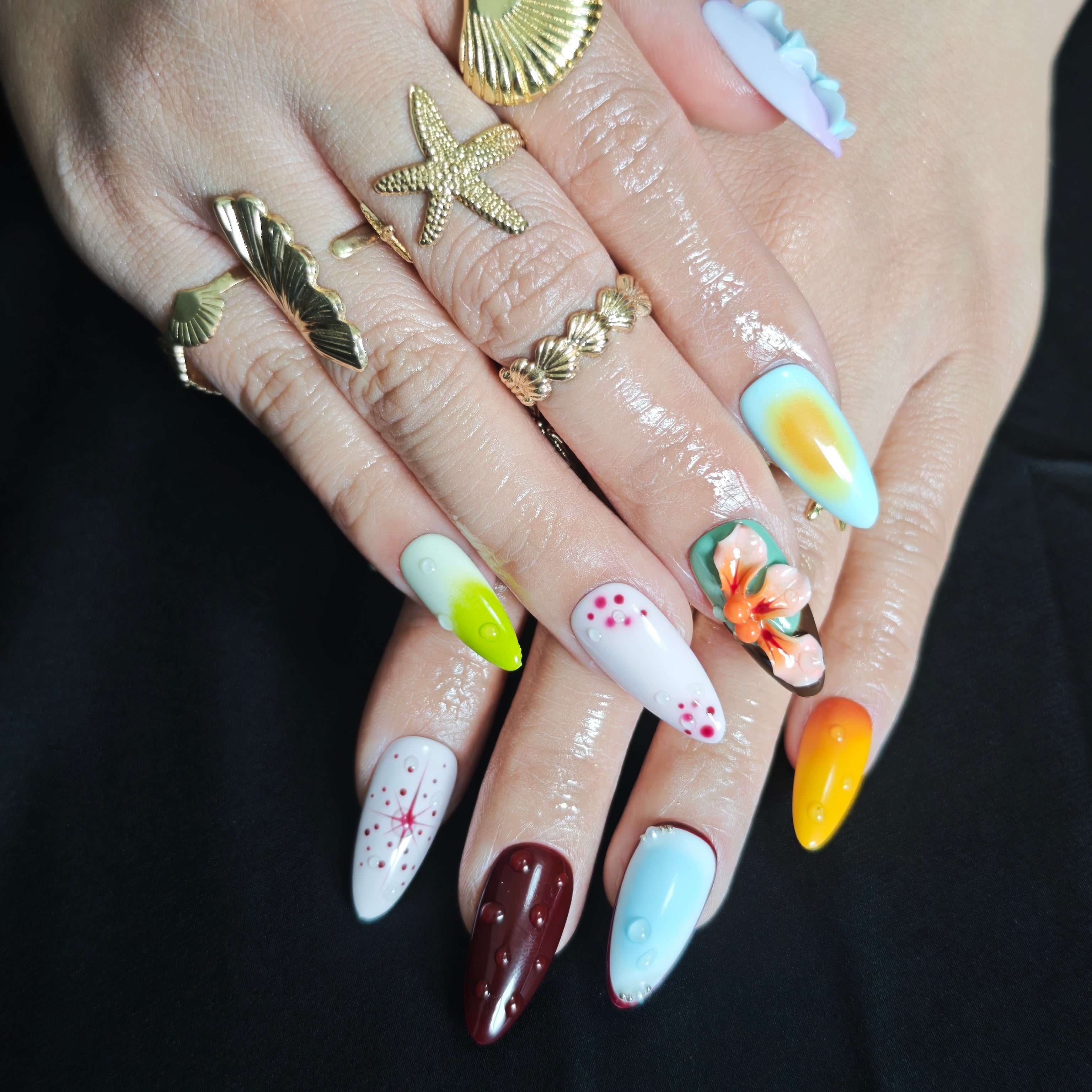 Elegant almond press on nails with handmade floral nail art for vacation and party looks