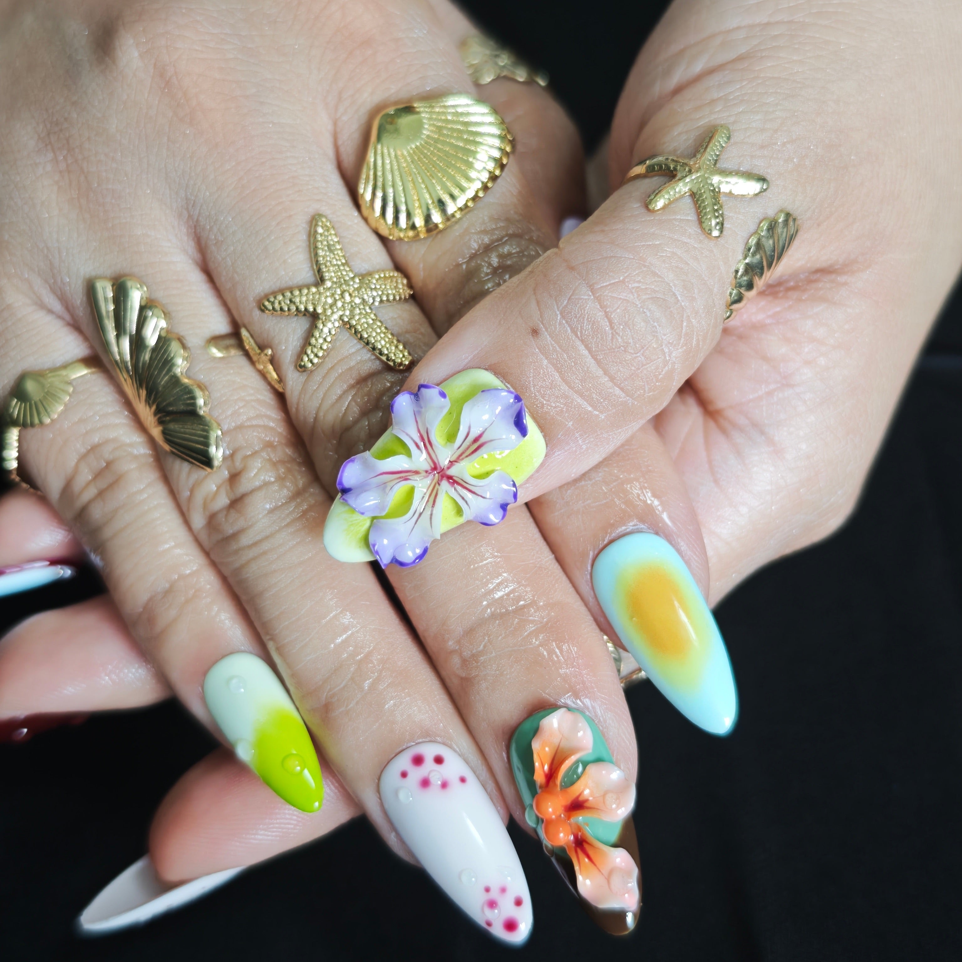 Close up view of handcrafted 3D flowers with realistic gradient petals on luxury gel nails