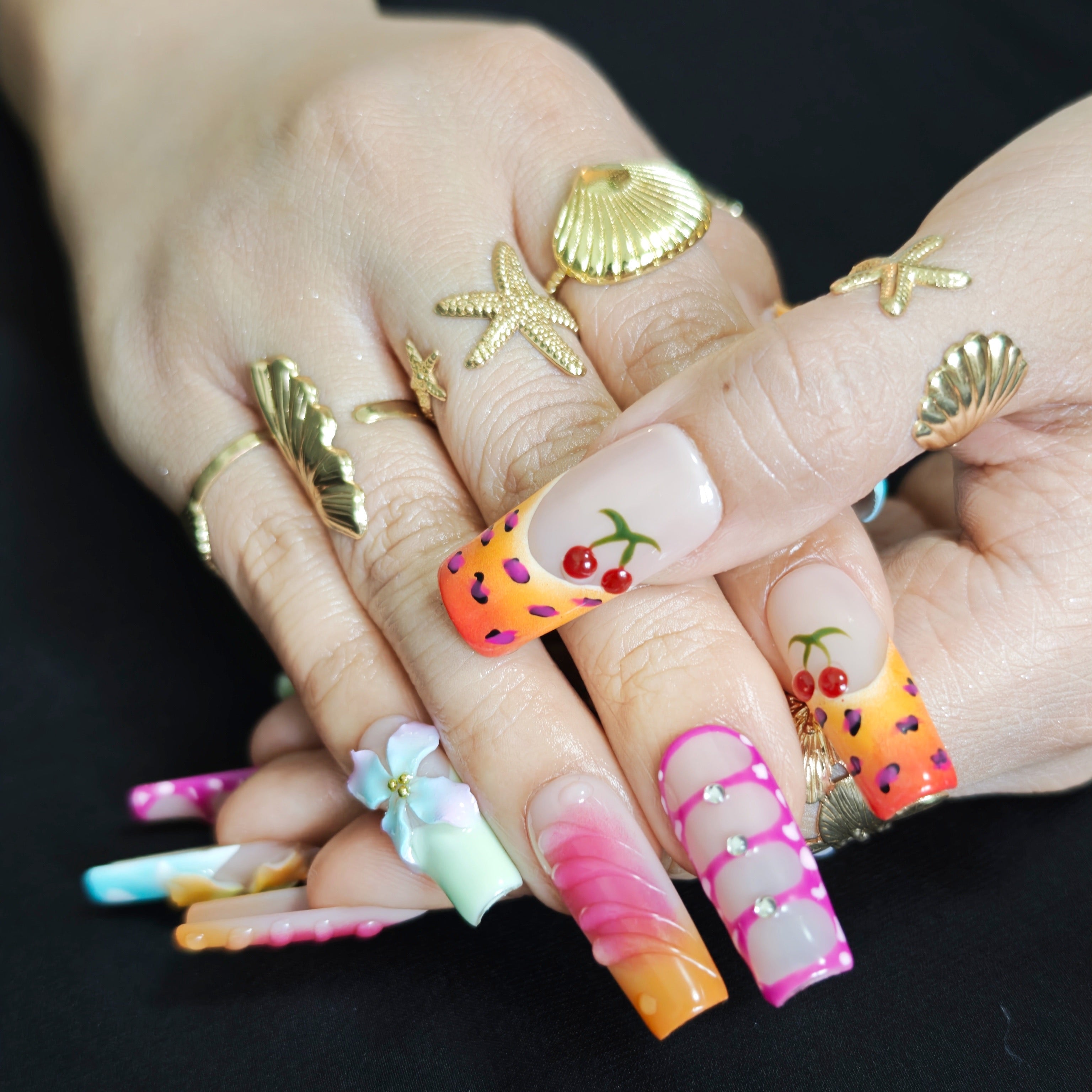 Close up of 3D flowers cherry details and sparkling accents on luxury press on nails