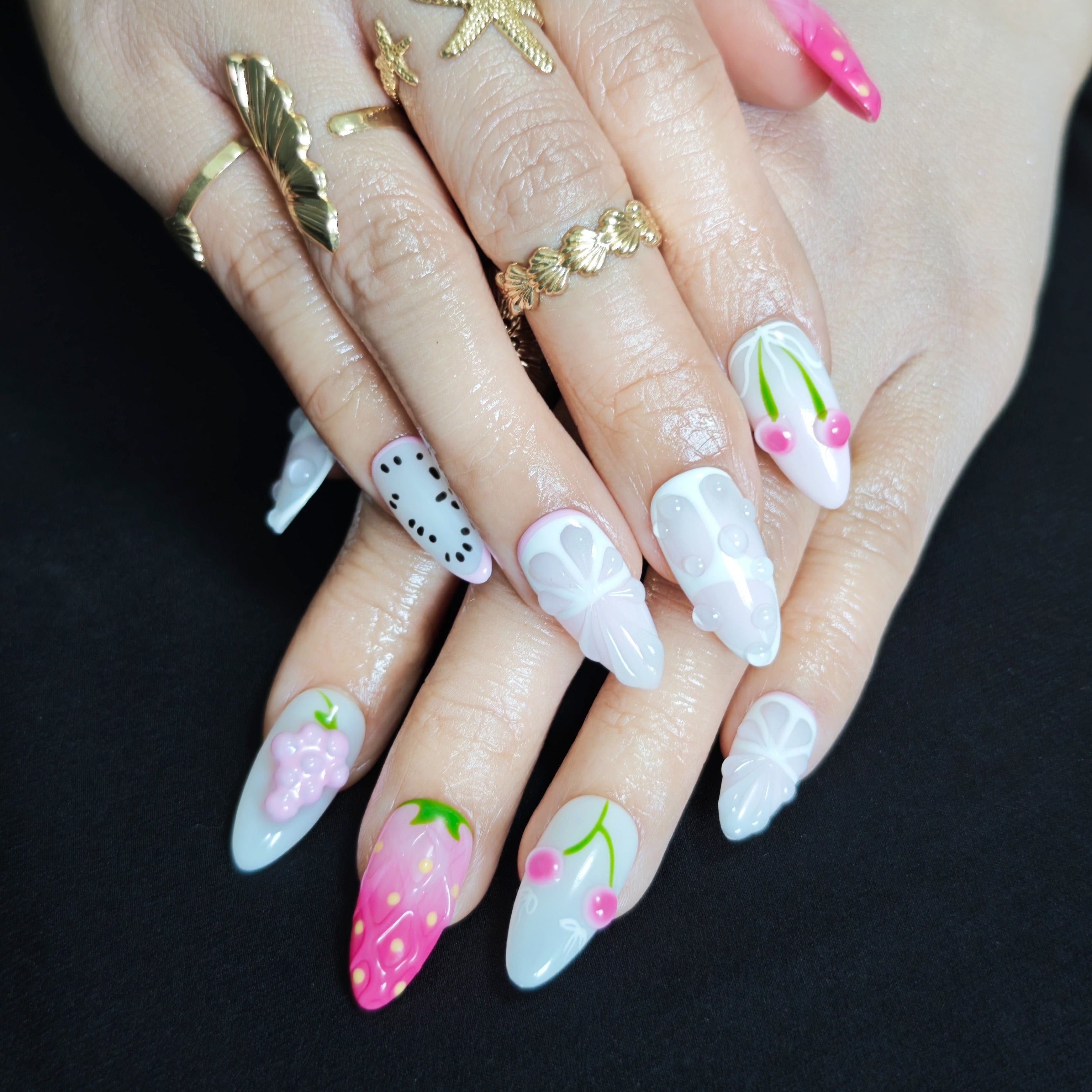 Pink and white almond press on nails with handcrafted cherry orange and strawberry nail art