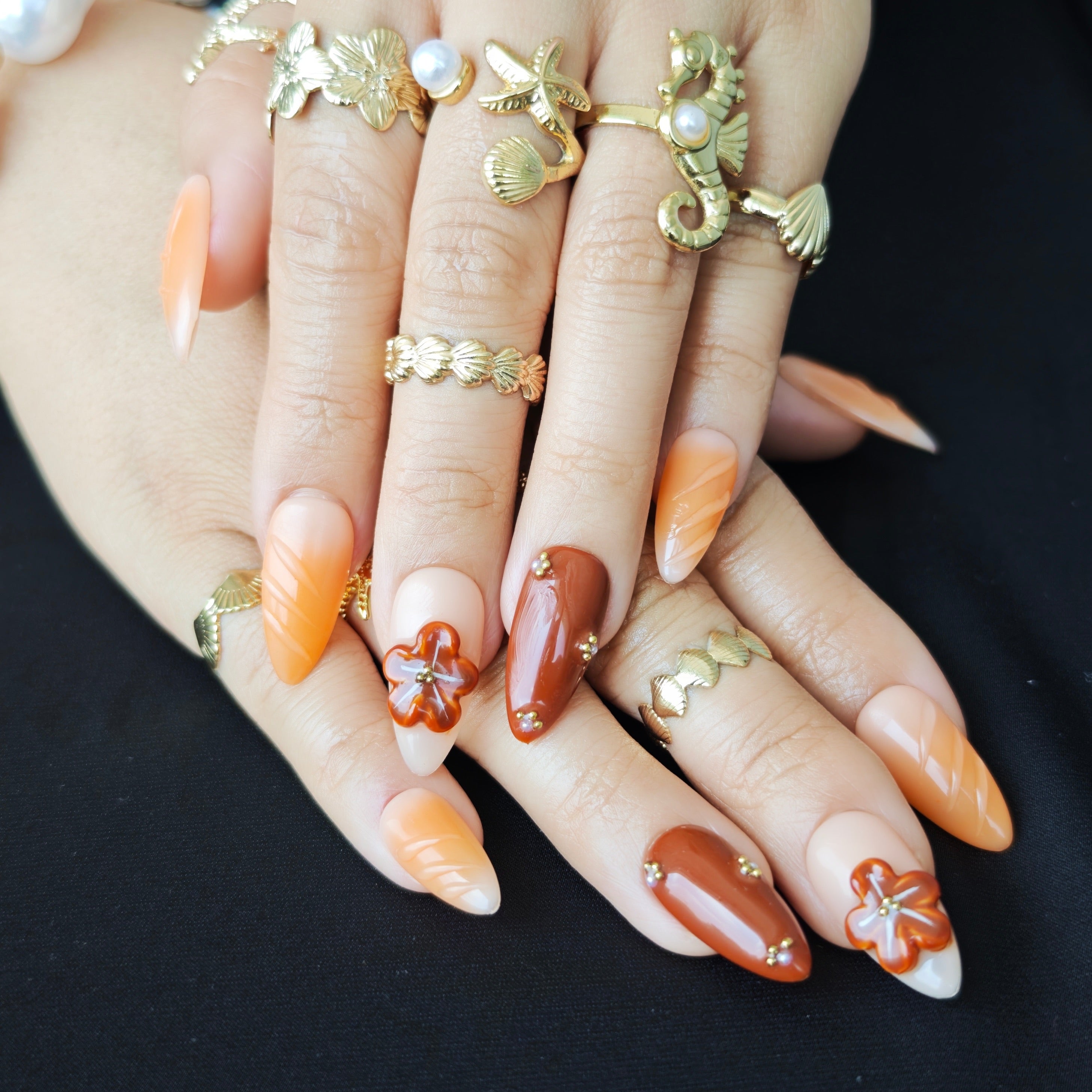 Orange mocha caramel press-on nails with 3D shell-inspired floral sculpture, handmade luxury design with intricate detailing.