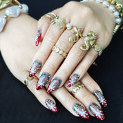 Christmas-themed almond press-on nails with delicate snowflake designs for a festive winter look.