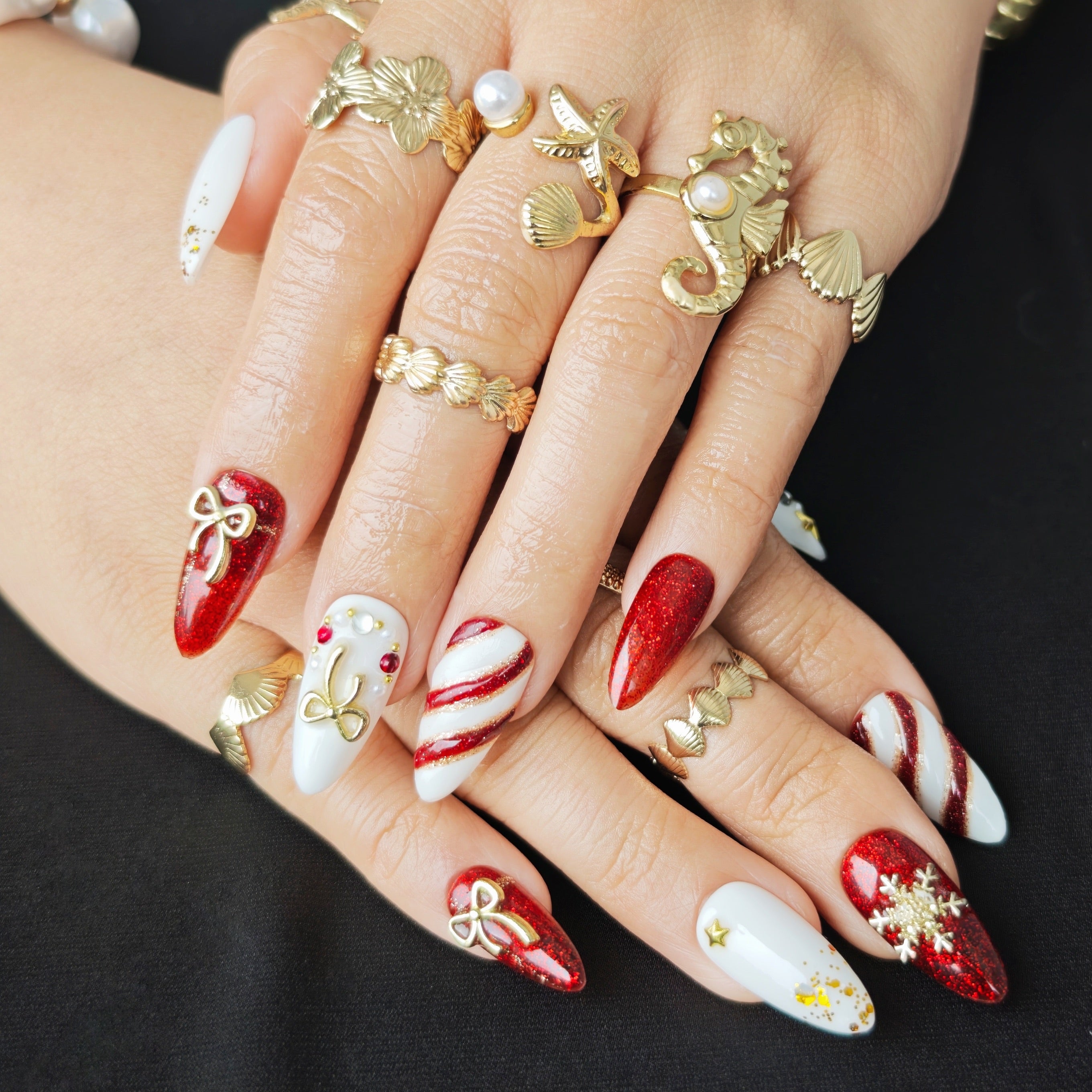Christmas almond-shaped press-on nails with red and white striped 3D candy-inspired design for a festive holiday look