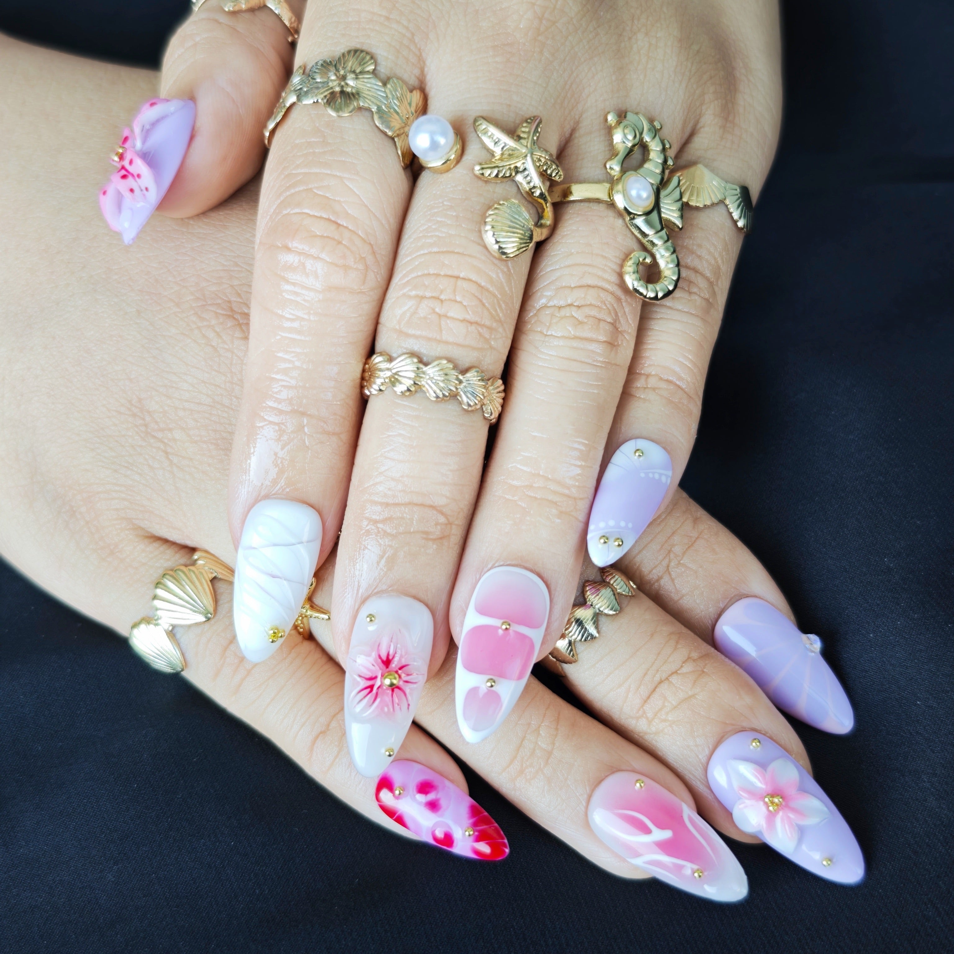 Close up of handcrafted 3D flowers and watercolor details on luxury press on nails