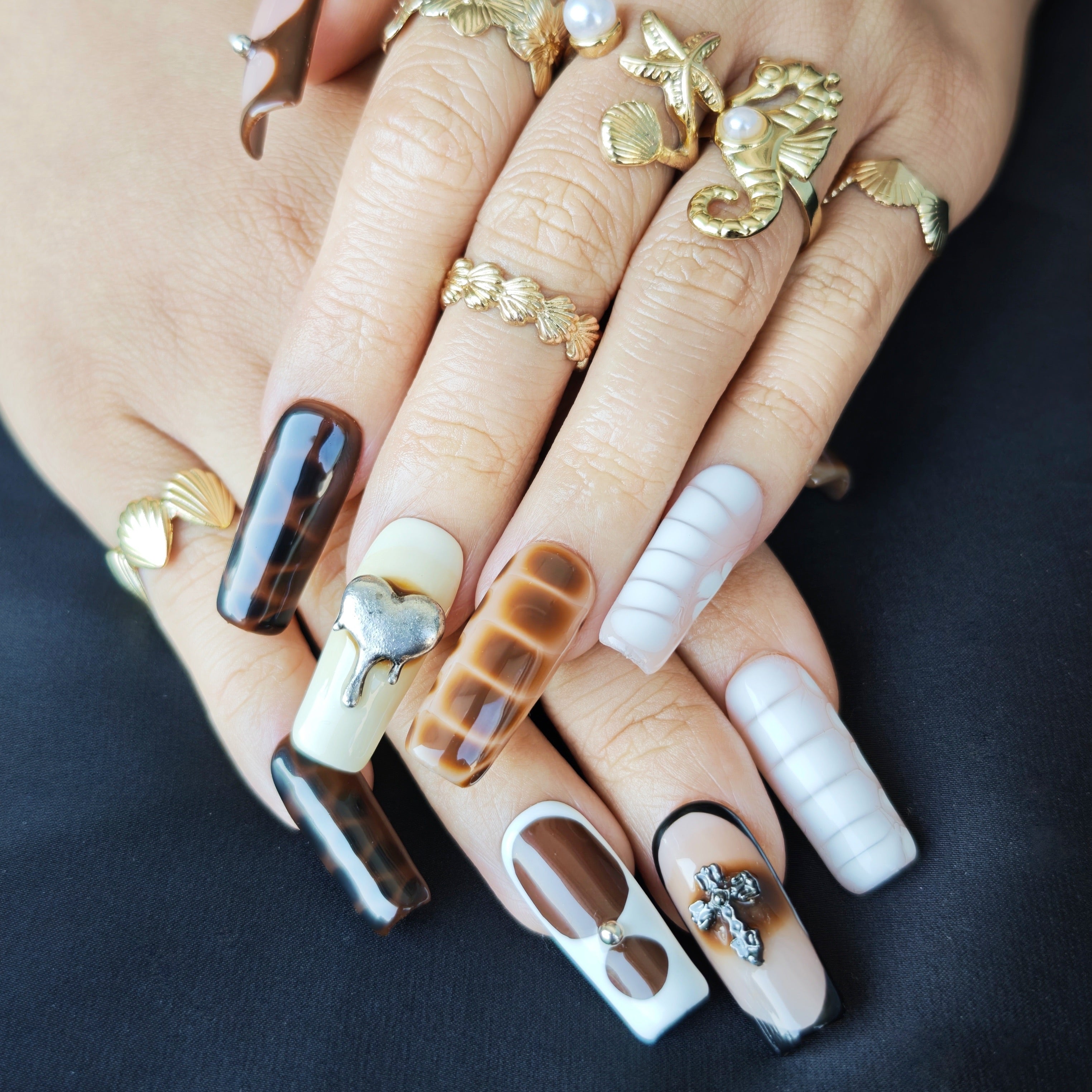 Hand wearing Wild Safari long square press-on nails with earthy brown animal texture nail art