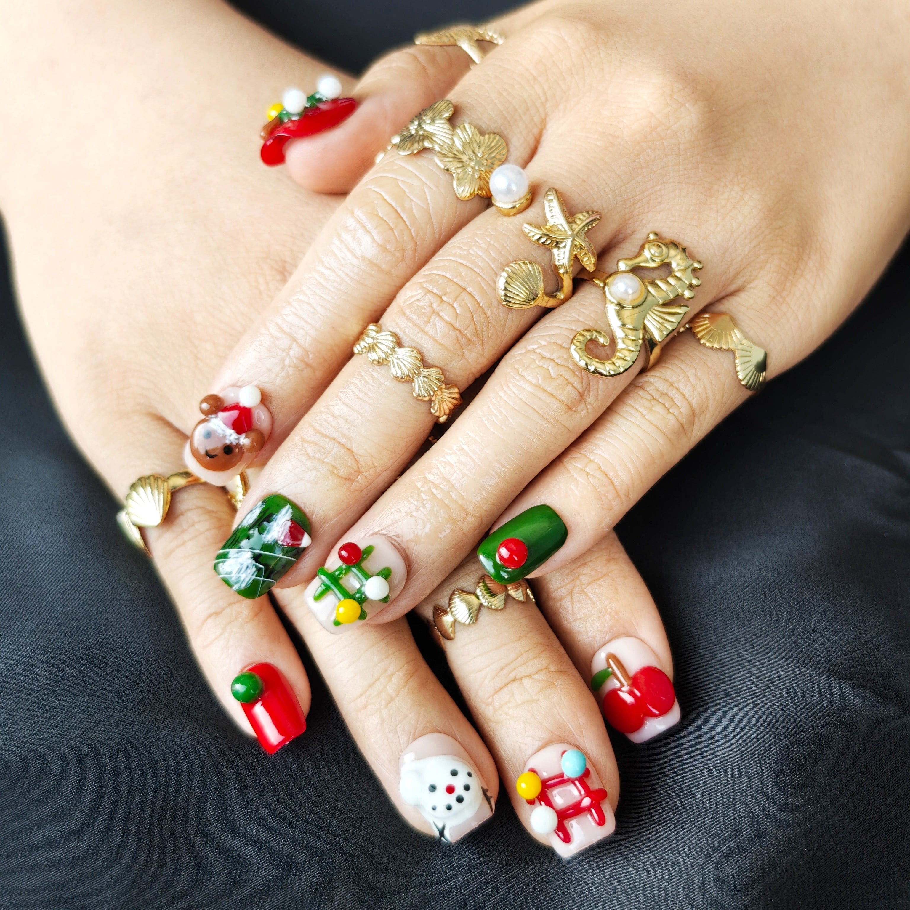 Cute short square Christmas press-on nails with colorful 3D gingerbread, Christmas tree, apple, and bear designs, office-friendly style