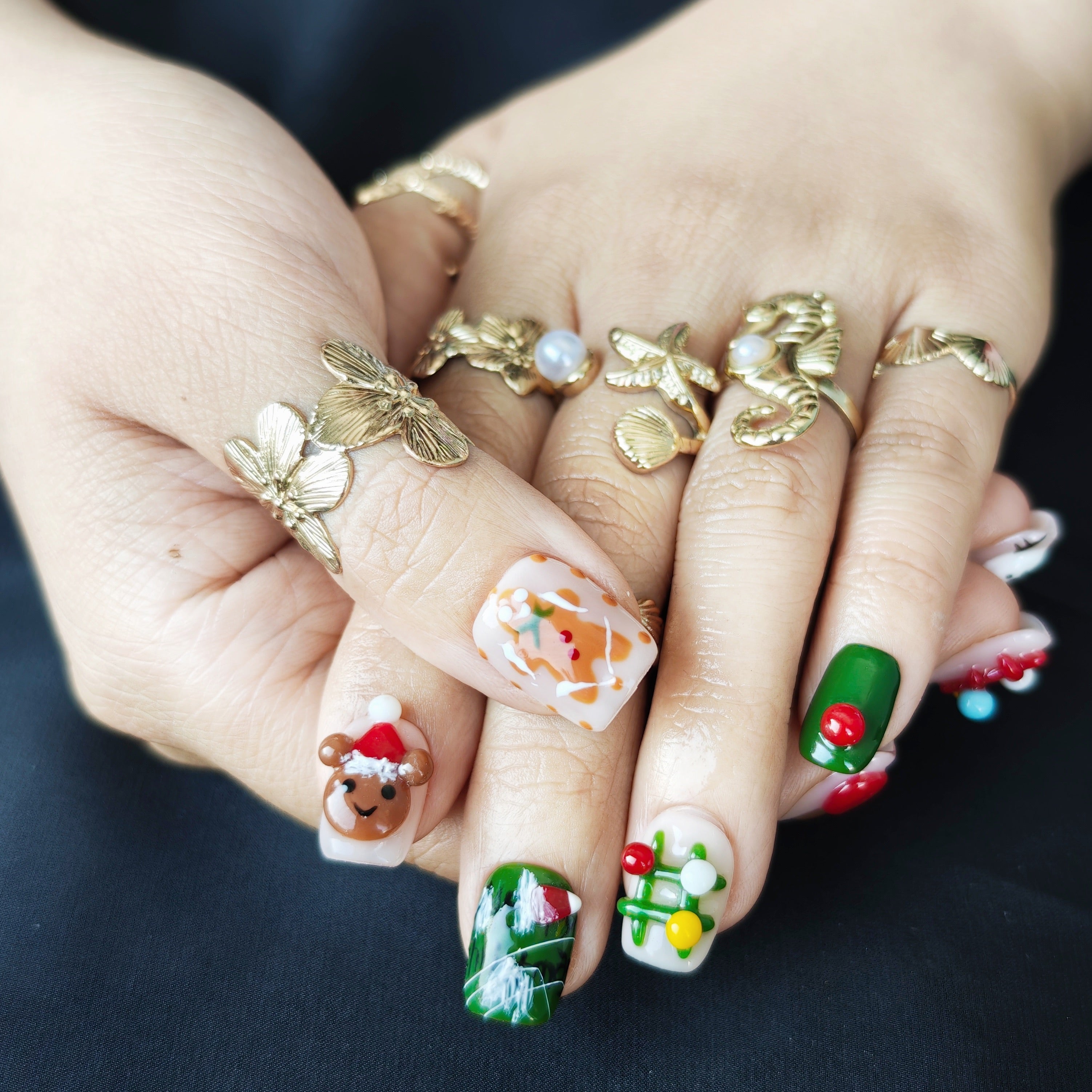 Cute short square Christmas press-on nails with colorful 3D gingerbread, Christmas tree, apple, and bear designs, office-friendly style