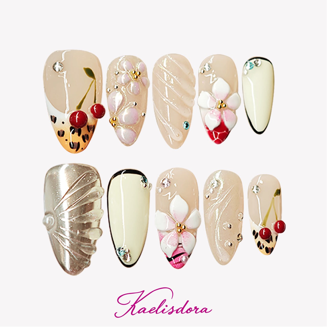 Handcrafted almond press-on nails in silver with 3D shell and cherry floral designs, luxurious and detailed.