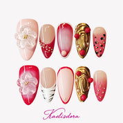 Red and gold transparent press-on nails with large 3D handcrafted petals, featuring an intricate luxury design.