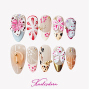 Flora Island 3D orange almond press-on nails featuring tropical inspired design with handmade floral details, colorful accents, and luxury nail art