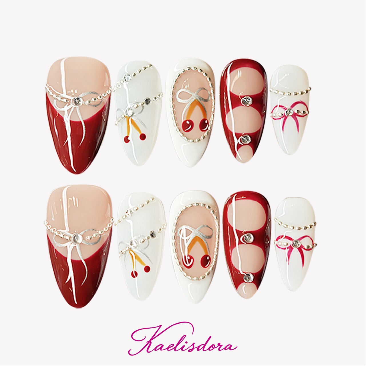White and red almond press-on nails with hand-painted cherry and silver pearl accents, luxurious festive winter design.