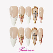 Divine Gold 3D stiletto press-on nails featuring nude base, gold metallic accents, embossed details, and luxury vintage nail art design