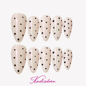 White polka dot almond-shaped press-on nails in minimal MIUMIU-inspired style, trendy for American high school teen girls