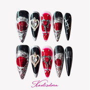 Black and red gothic stiletto press-on nails with silver crystal hearts, perfect for dark and edgy style lovers.