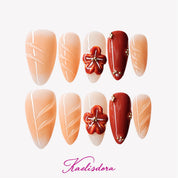 Orange mocha caramel press-on nails with 3D shell-inspired floral sculpture, handmade luxury design with intricate detailing.