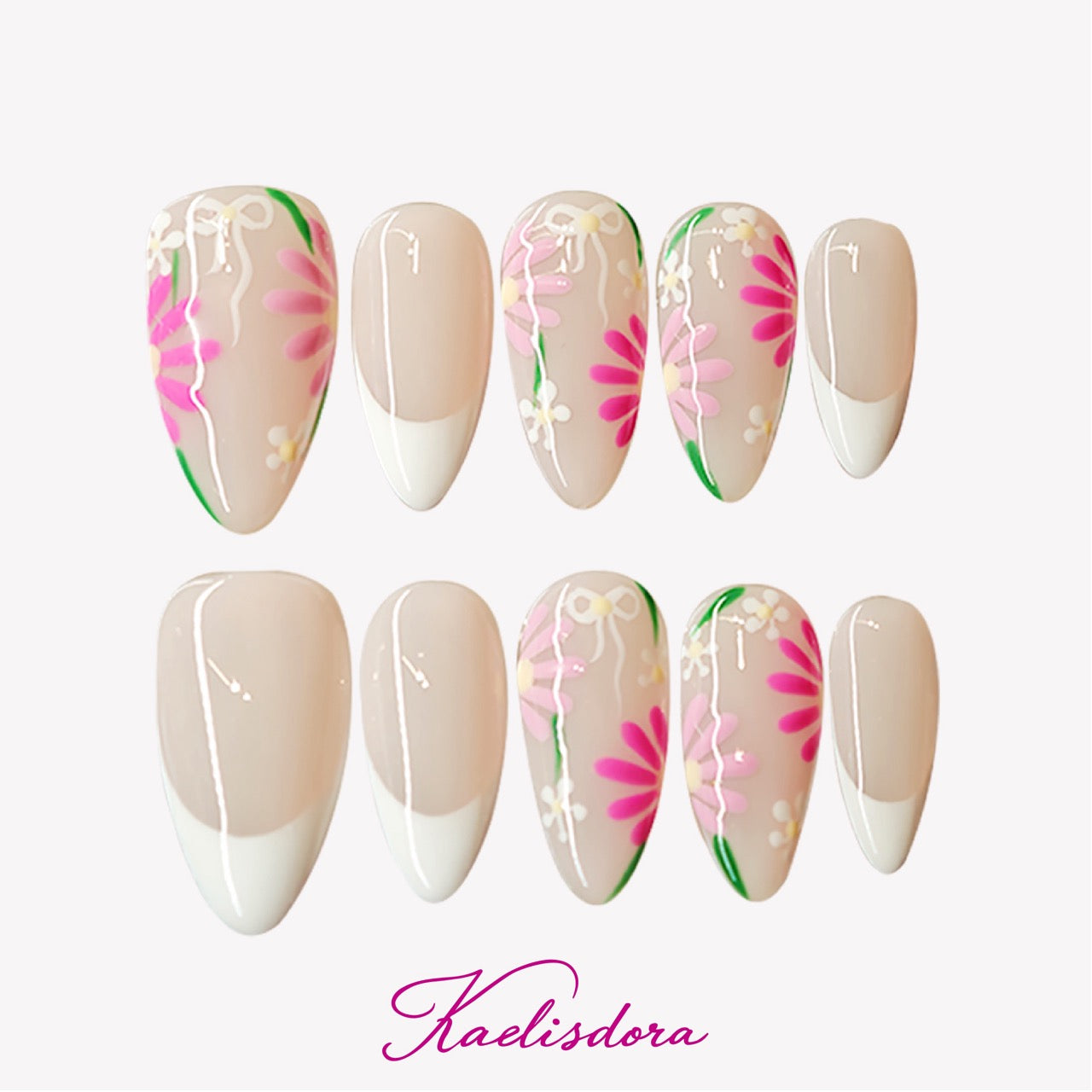French-style almond press-on nails in white and pink with small floral designs, creating a soft spring-inspired look.