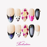 Almond press-on nails in black and purple with vibrant 3D floral designs, perfect for a bold, edgy style.