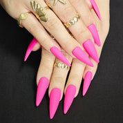 Fuchsia long pointed press-on nails, bold gothic style for party wear, expressing youthful attitude and edgy personality